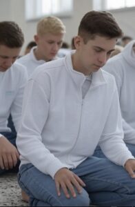 Teens praying at the Mosque